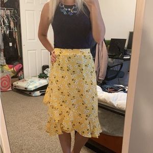 Yellow floral skirt. Mid length.